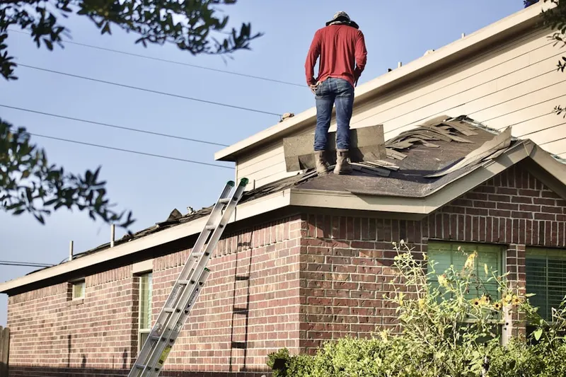 Professional roofer working on a residential roof in Catlett